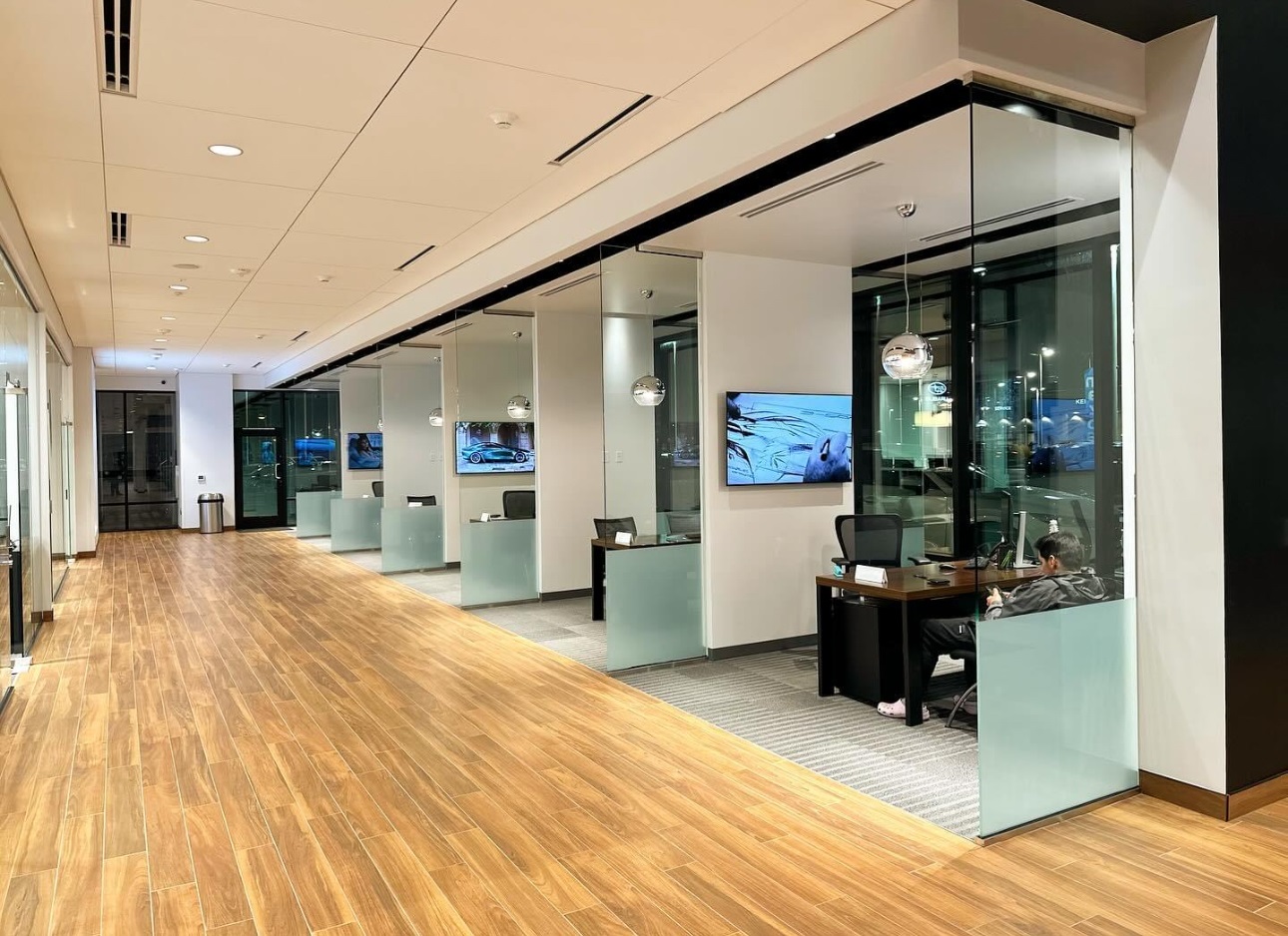 An interior shot of an commercial space with windows between each office.